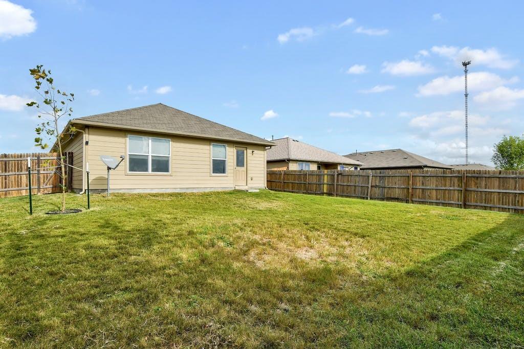 173 Rafe Court Kyle, TX 78640 - Photo 25 of 27 Rear view of house featuring a fenced backyard