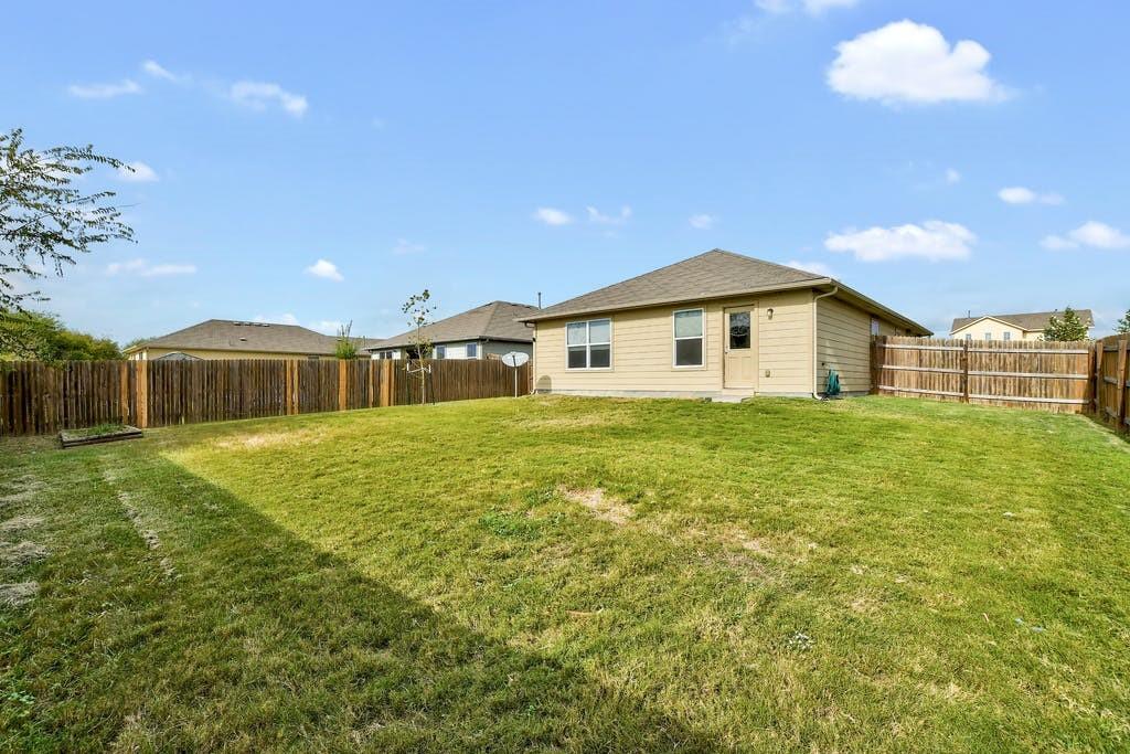 173 Rafe Court Kyle, TX 78640 - Photo 26 of 27 Back of house with a fenced backyard