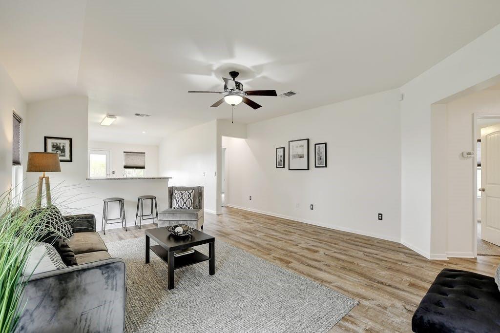 173 Rafe Court Kyle, TX 78640 - Photo 9 of 27 Living room with a ceiling fan and light wood finished floors