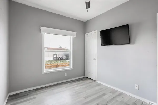 a view of empty room with wooden floor
