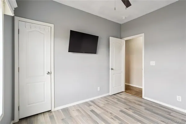 a bathroom with a granite countertop toilet sink and mirror