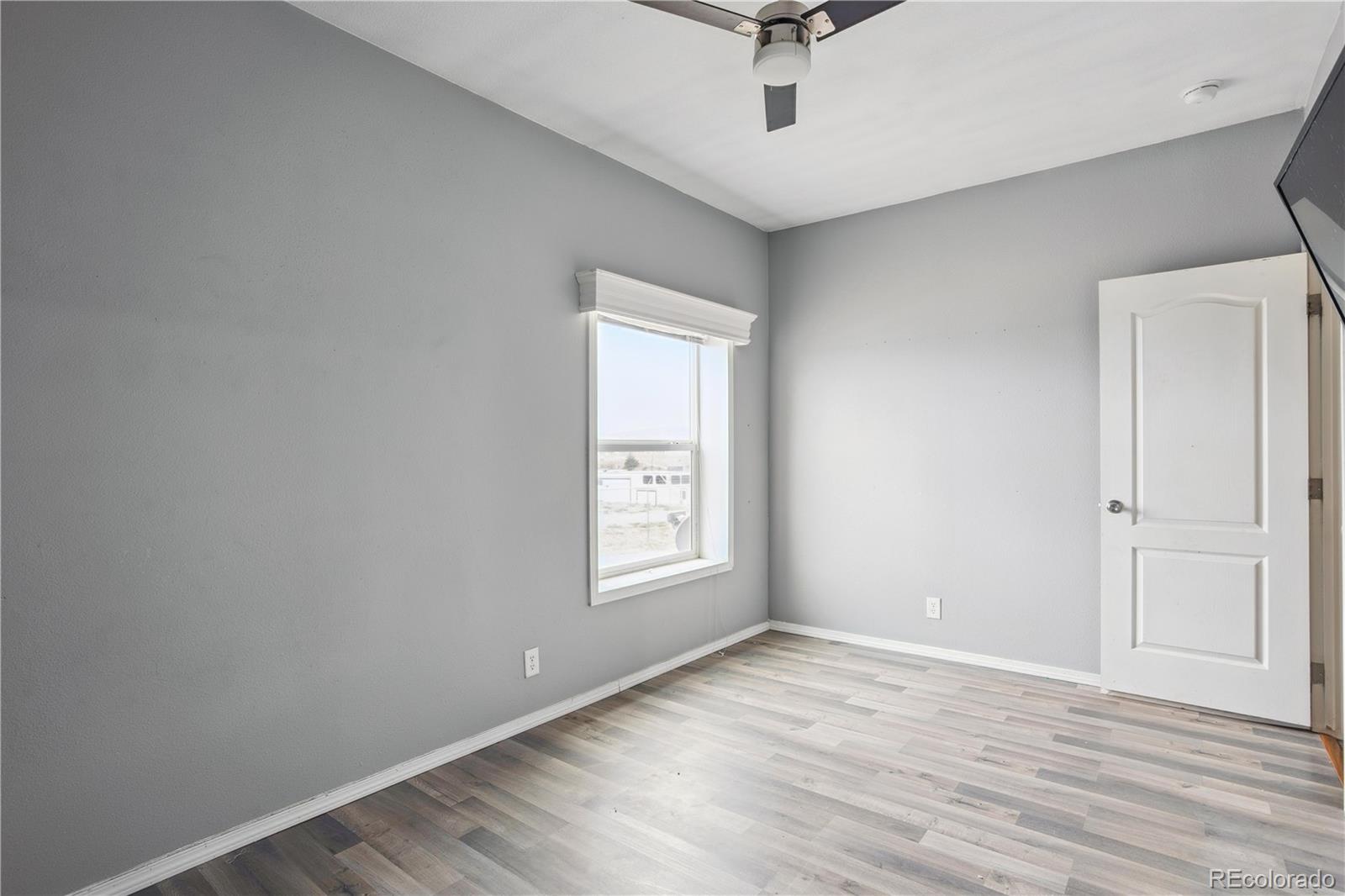 125 12th Street Fairplay, CO 80440 - Photo 22 of 31 wooden floor in an empty room with a window