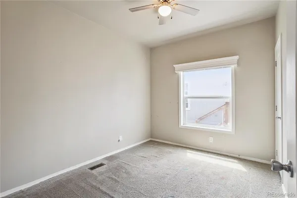 an empty room with windows and closet