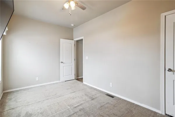 a view of a livingroom with an empty space and a window