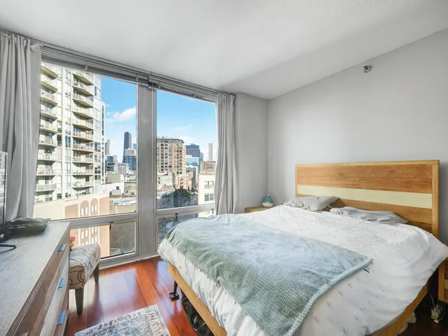 a bed sitting in a bedroom next to a large window