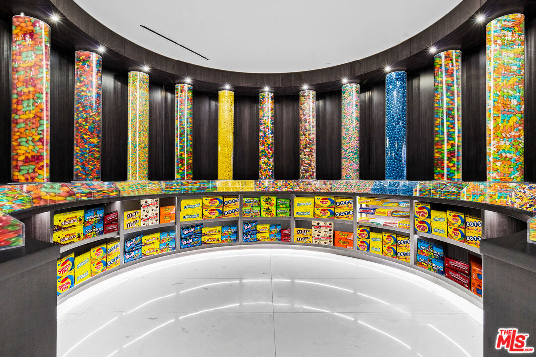 944 Airole Way Los Angeles, CA 90077 - Photo 19 of 30 a bathroom with a tub a sink and a large mirror