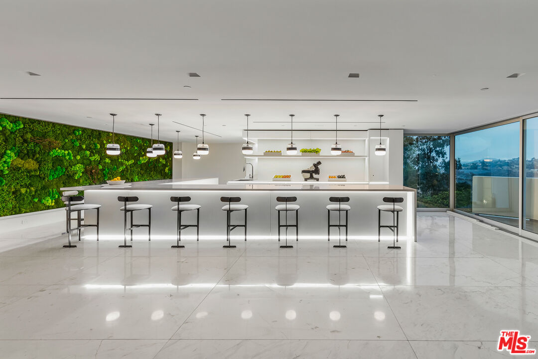 944 Airole Way Los Angeles, CA 90077 - Photo 20 of 30 a living room with lots of furniture and white walls