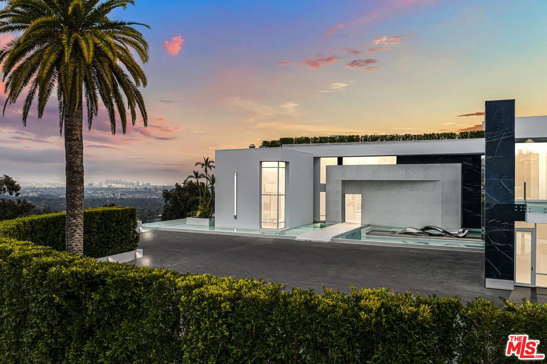 944 Airole Way Los Angeles, CA 90077 - Photo 24 of 30 a front view of a house with a garden