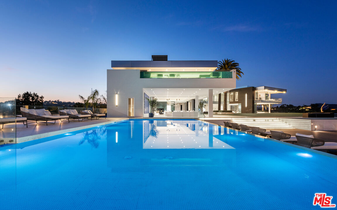 944 Airole Way Los Angeles, CA 90077 - Photo 25 of 30 a living room with furniture and a table with potted plants