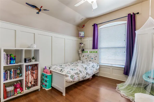 a bedroom with a bed and a book shelf