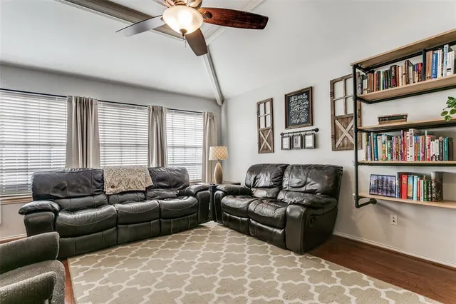 a living room with furniture and a book shelf