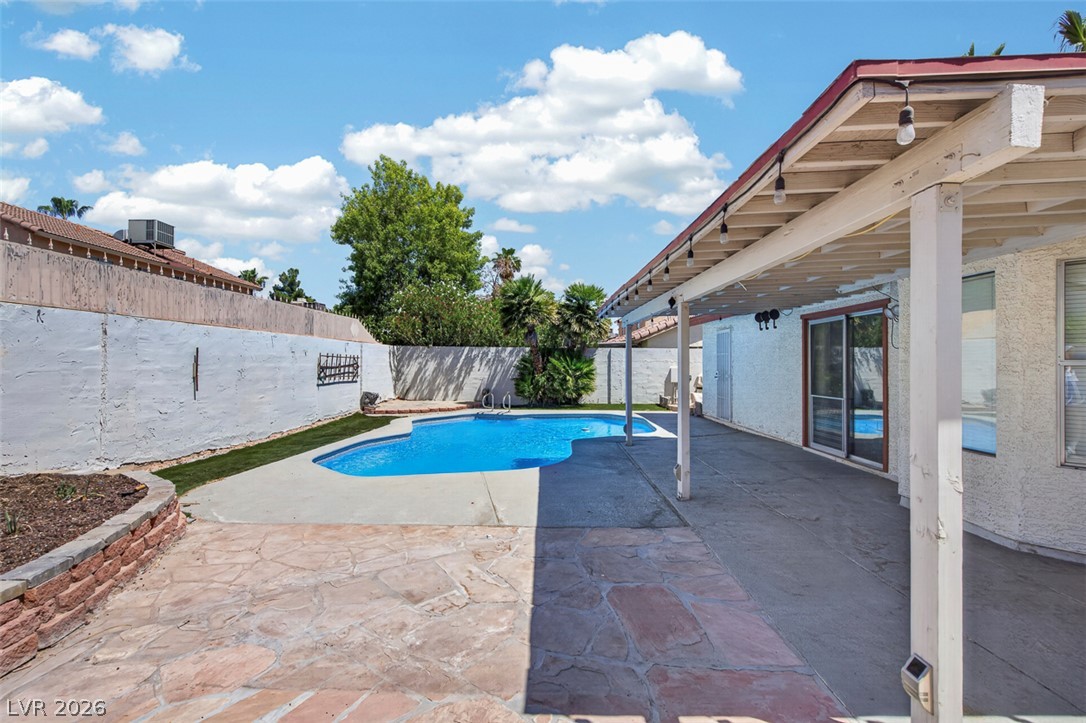 2609 Shakespeare Road Las Vegas, NV 89108 - Photo 32 of 41 An inviting backyard oasis offers a sparkling pool, generous patio, and shaded outdoor living space.