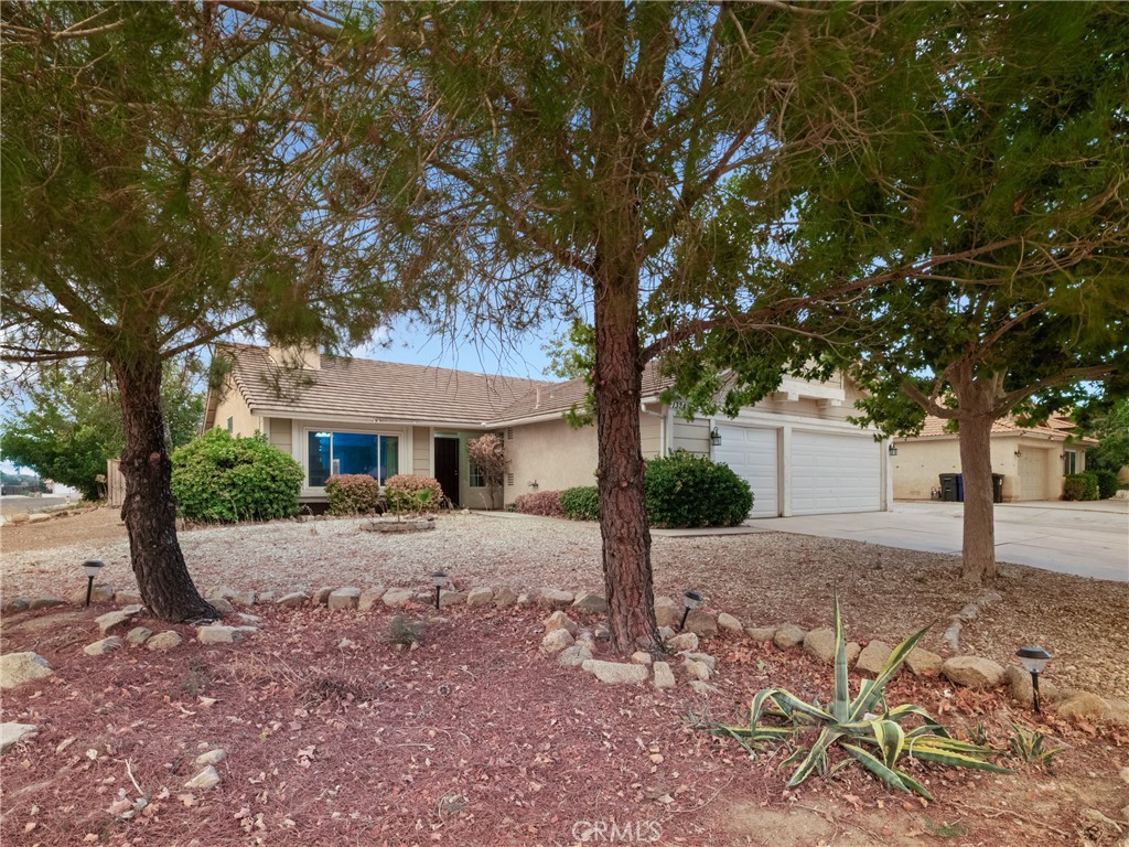 13243 Cardinal Road Victorville, CA 92392 - Photo 1 of 1 a house with trees in front of it