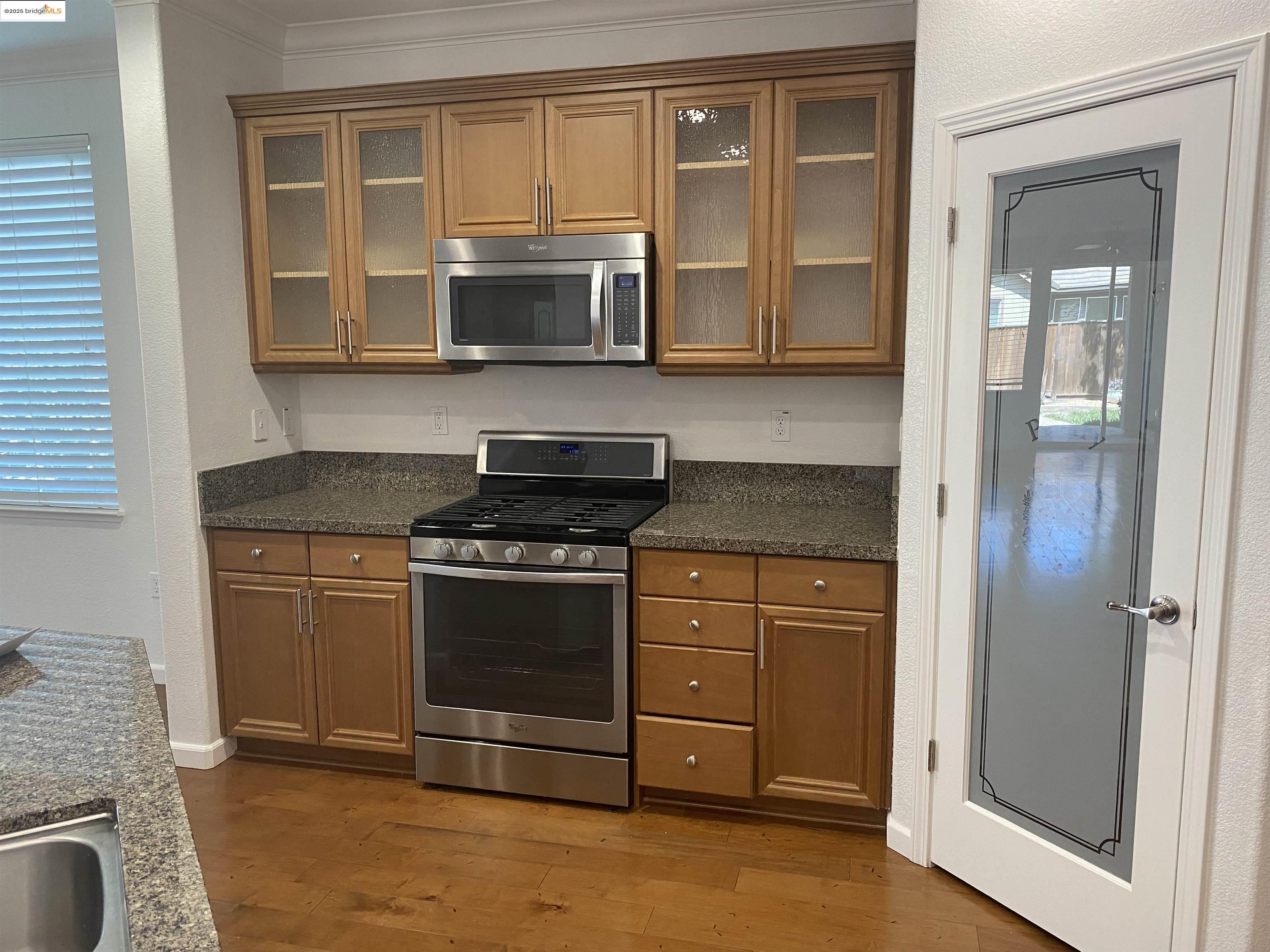 9821 Key W Way Discovery Bay, CA 94505 - Photo 5 of 14 a kitchen with stainless steel appliances granite countertop a stove and a microwave