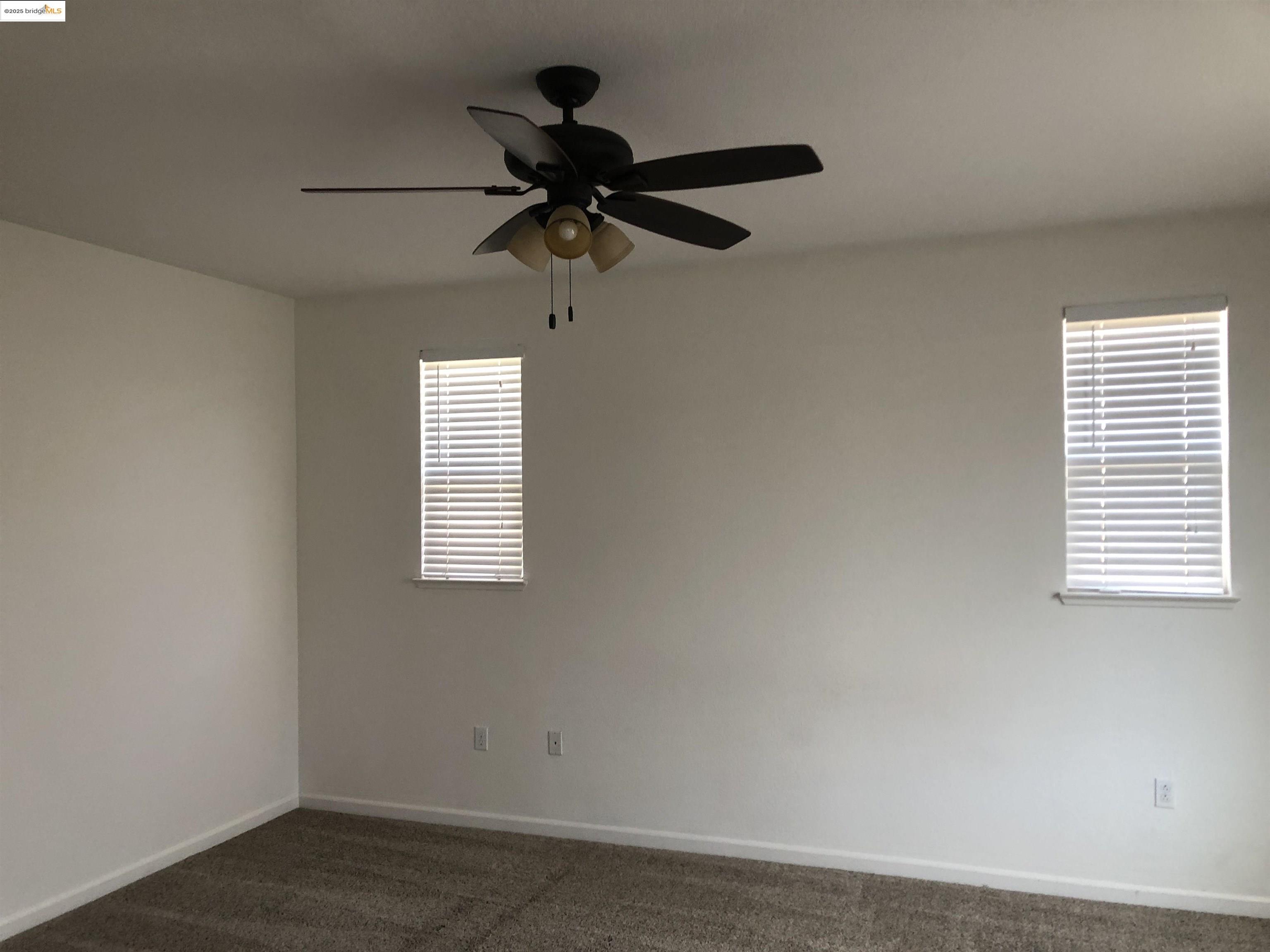 9821 Key W Way Discovery Bay, CA 94505 - Photo 7 of 14 an empty room with a window and a fan