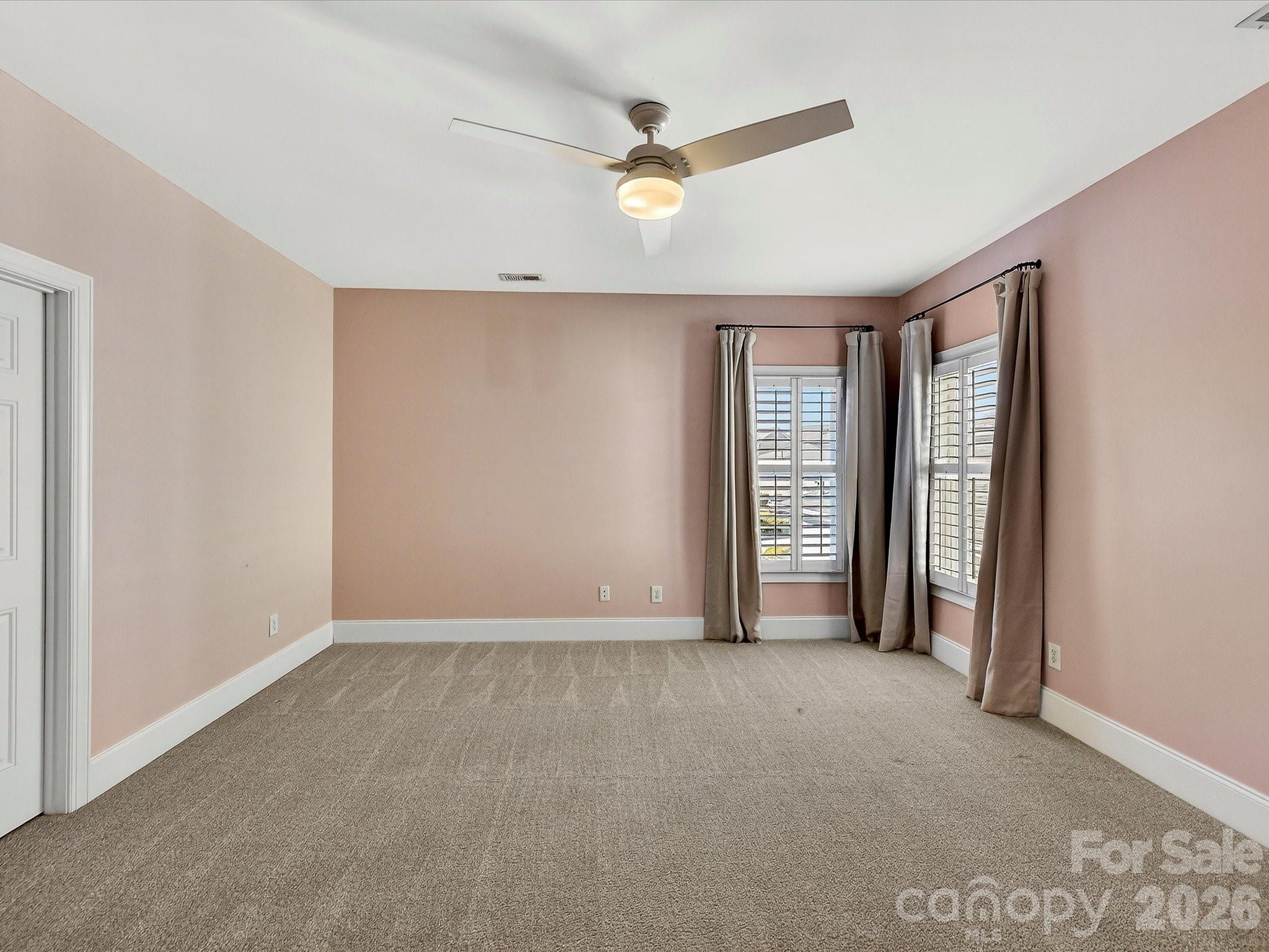 10030 Triple Oak Road Charlotte, NC 28277 - Photo 37 of 48 an empty room with windows and a ceiling fan
