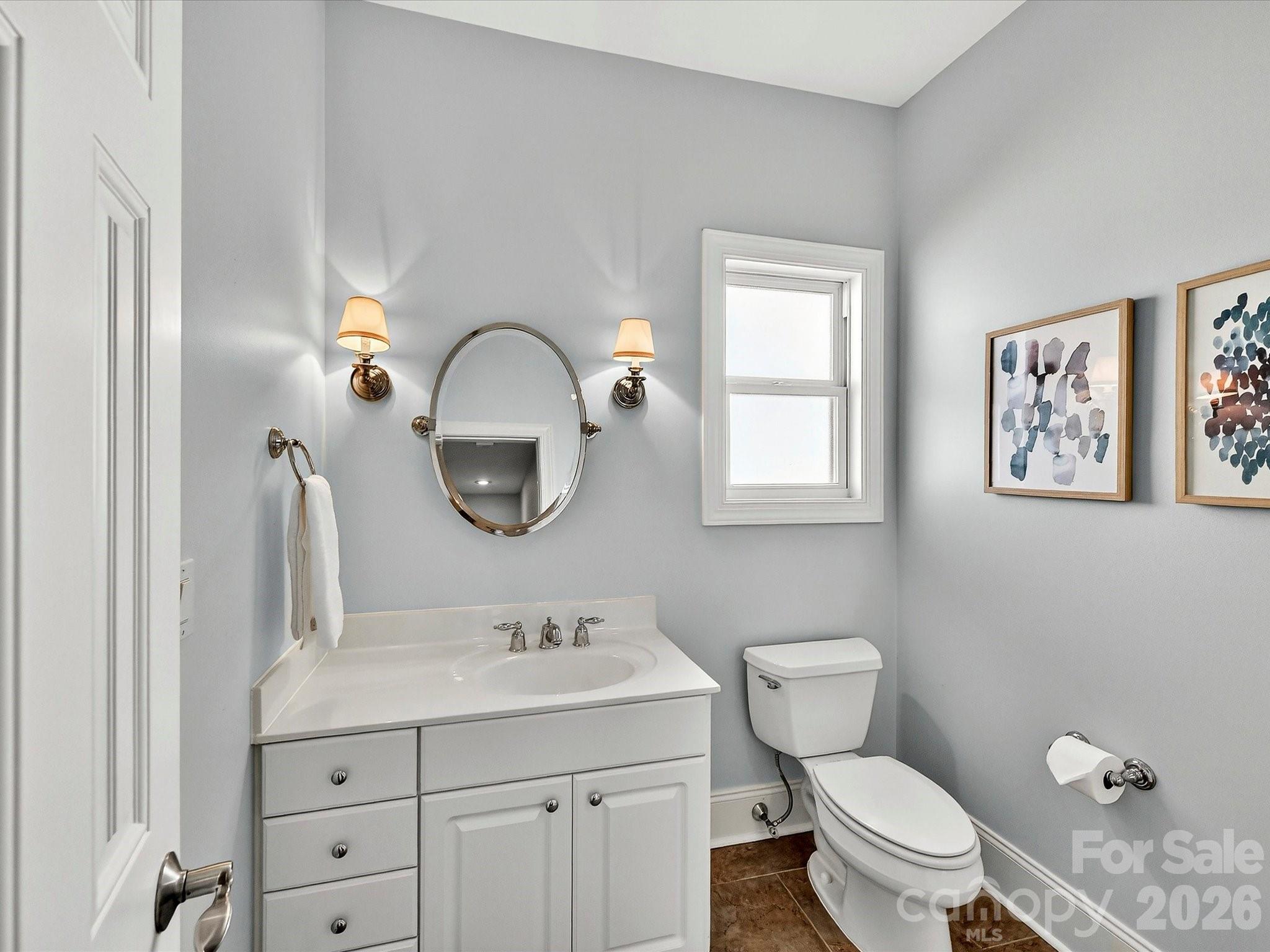 10030 Triple Oak Road Charlotte, NC 28277 - Photo 38 of 48 a bathroom with a toilet a sink and a mirror