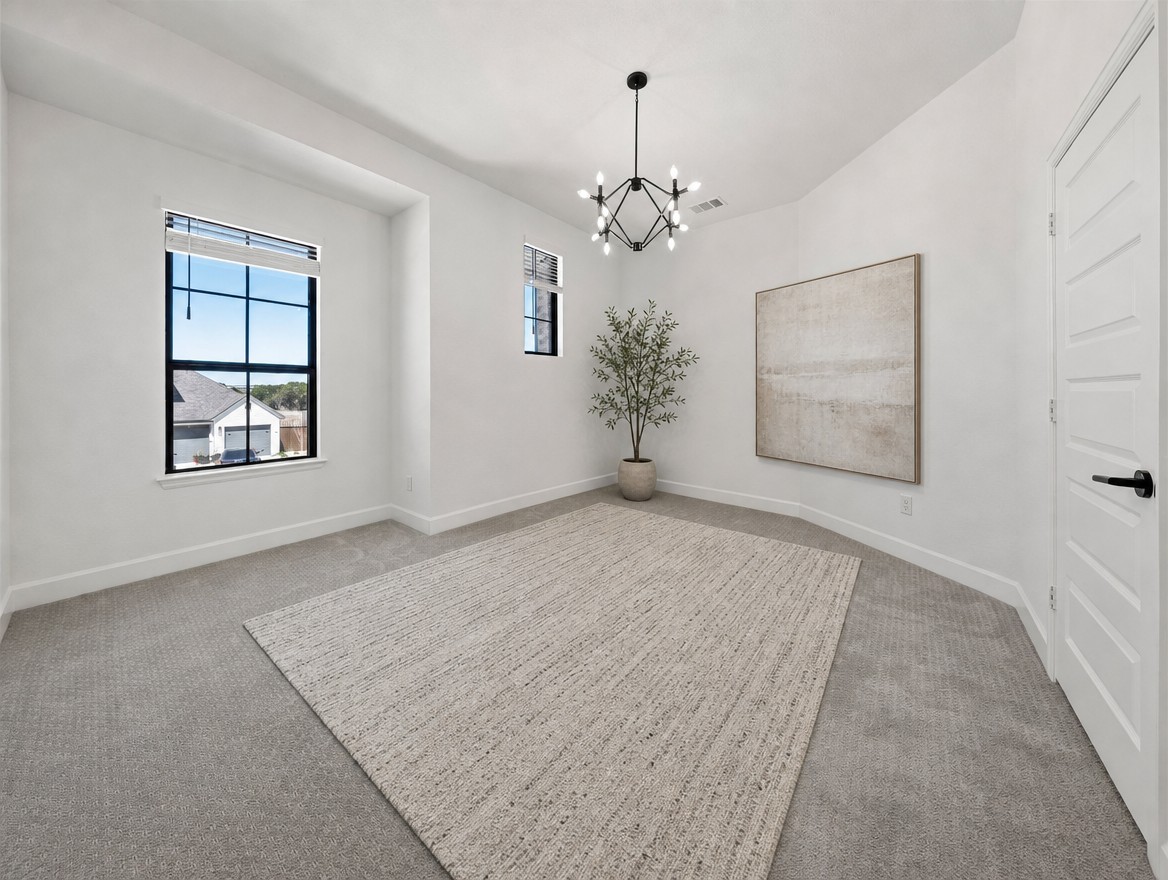 1440 Riva Ridge Drive Leander, TX 78641 - Photo 26 of 37 A well-lit bedroom features plush carpeting and a striking modern chandelier, ready for personalization.