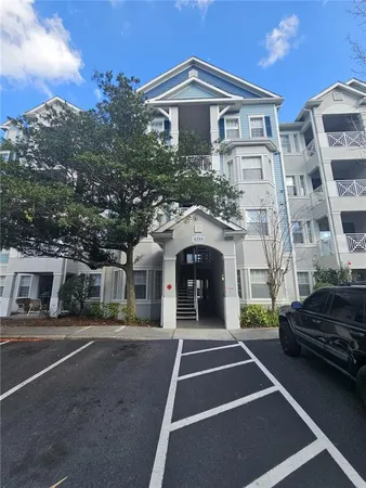 a front view of a building with parking area