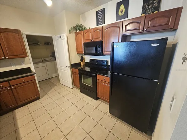 a kitchen with stainless steel appliances a refrigerator and a stove top oven