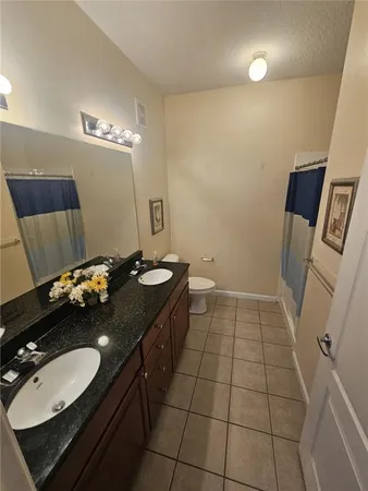 a bathroom with a sink vanity and a mirror