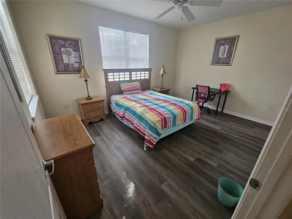 a bedroom with a bed and a desk