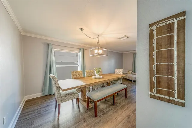 a very nice looking room with a large window and chandelier