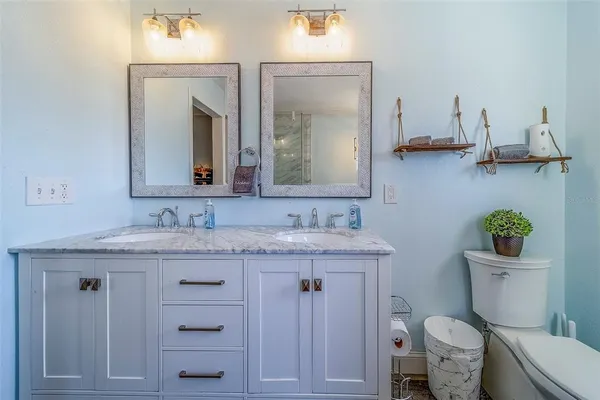a white bath tub sitting next to a bathroom sink