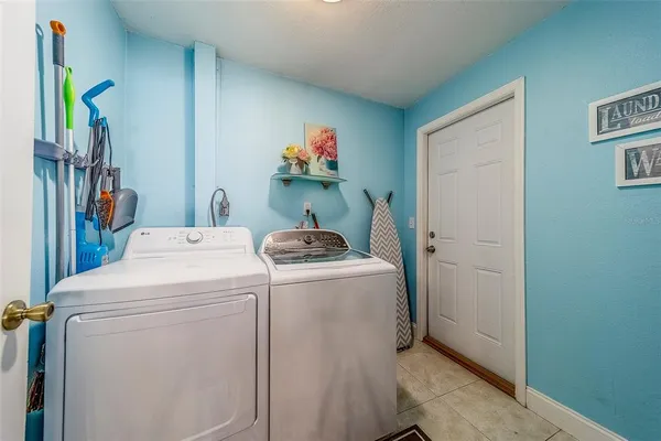 a view of kitchen with stainless steel appliances cabinets and a window