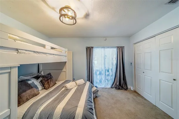 a bedroom with a bed and a couch