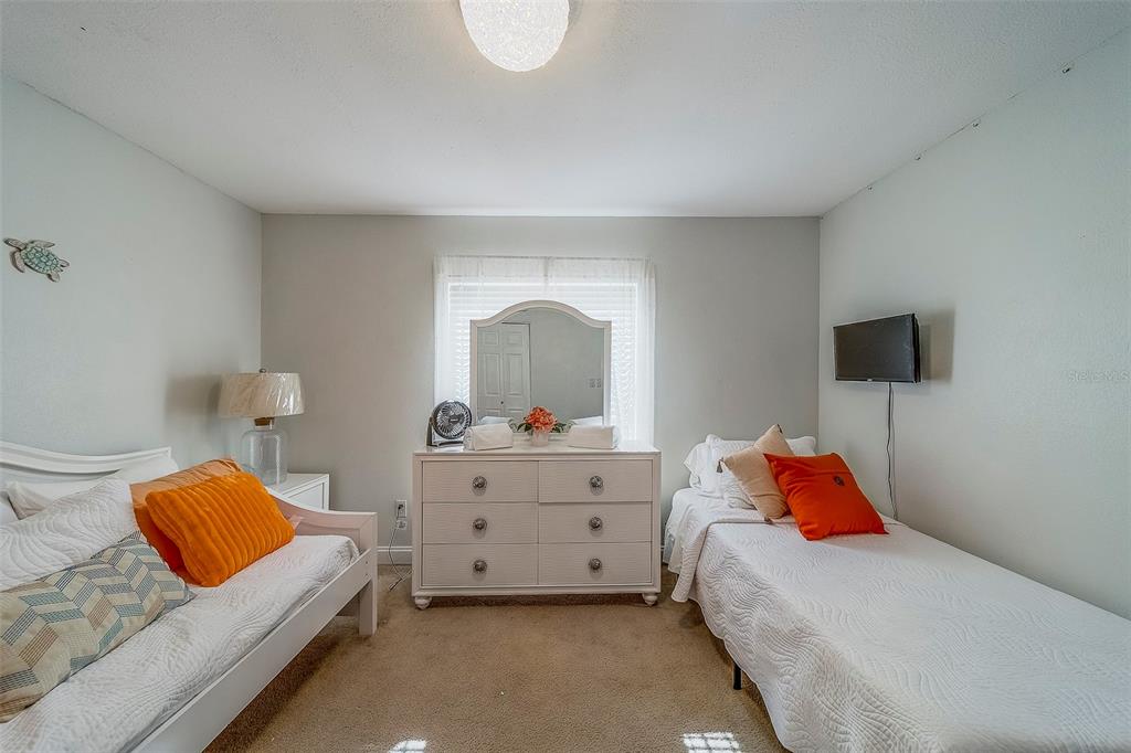 14414 91st Avenue North Seminole, FL 33776 - Photo 33 of 58 a bedroom with a bed and a window