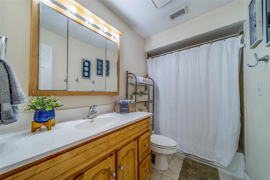 14414 91st Avenue North Seminole, FL 33776 - Photo 36 of 58 a bathroom with a sink a toilet and shower