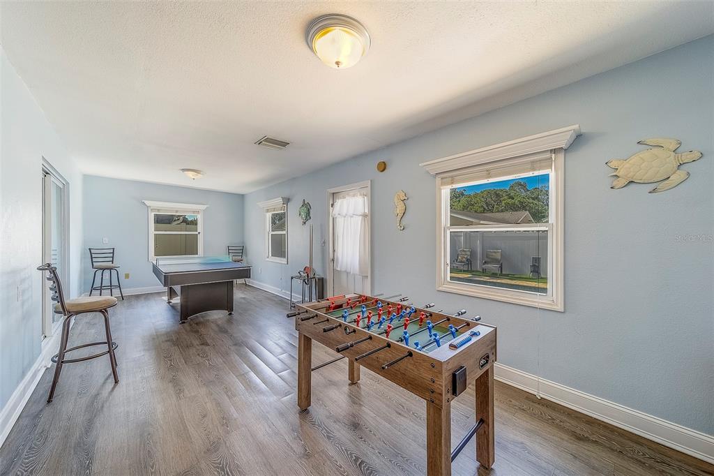 14414 91st Avenue North Seminole, FL 33776 - Photo 38 of 58 a living room with furniture and a table
