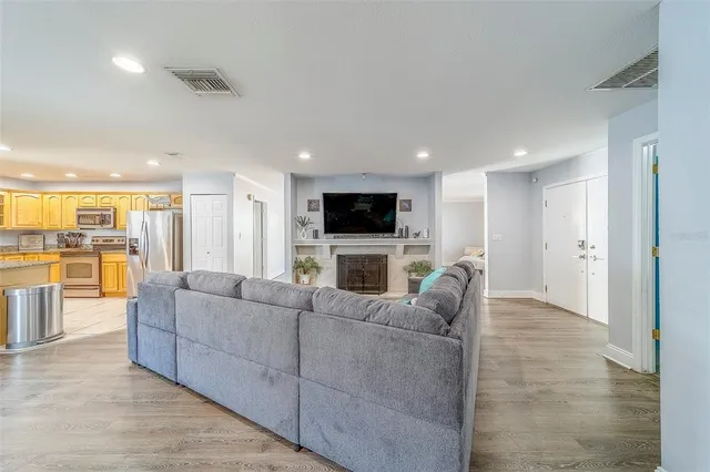 a living room with furniture wooden floor and a flat screen tv