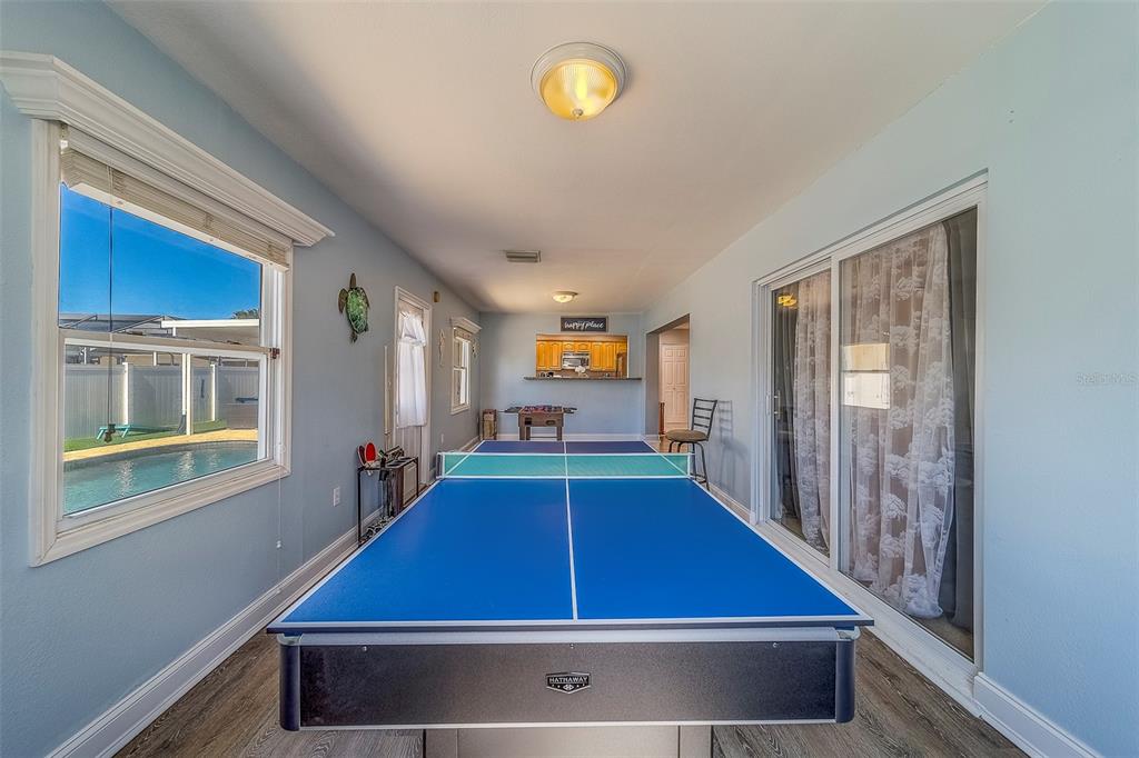 14414 91st Avenue North Seminole, FL 33776 - Photo 42 of 58 a room with pool table and windows