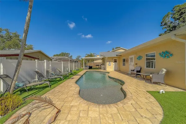 a view of a backyard with couches table and chairs