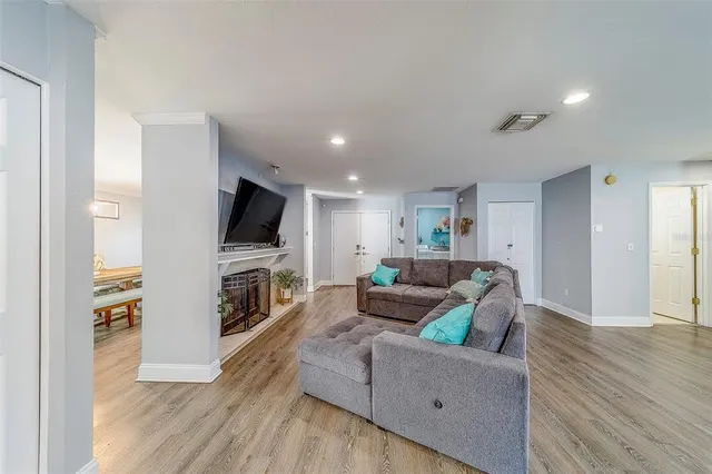 a view of a room with wooden floor and furniture