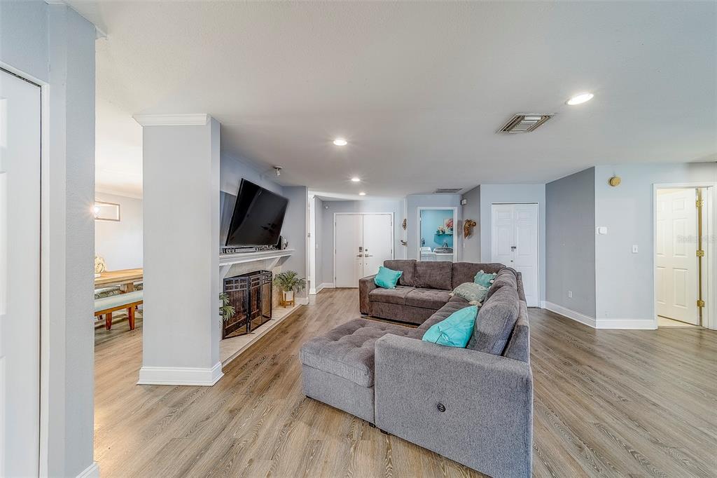 14414 91st Avenue North Seminole, FL 33776 - Photo 5 of 58 a living room with furniture wooden floor and a flat screen tv