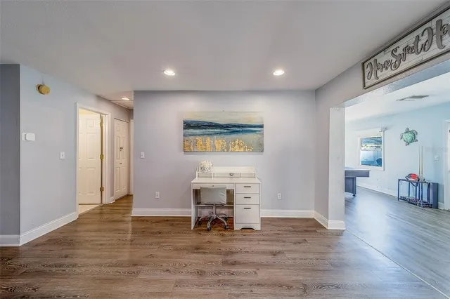 a view of a kitchen with kitchen island wooden floor and living room