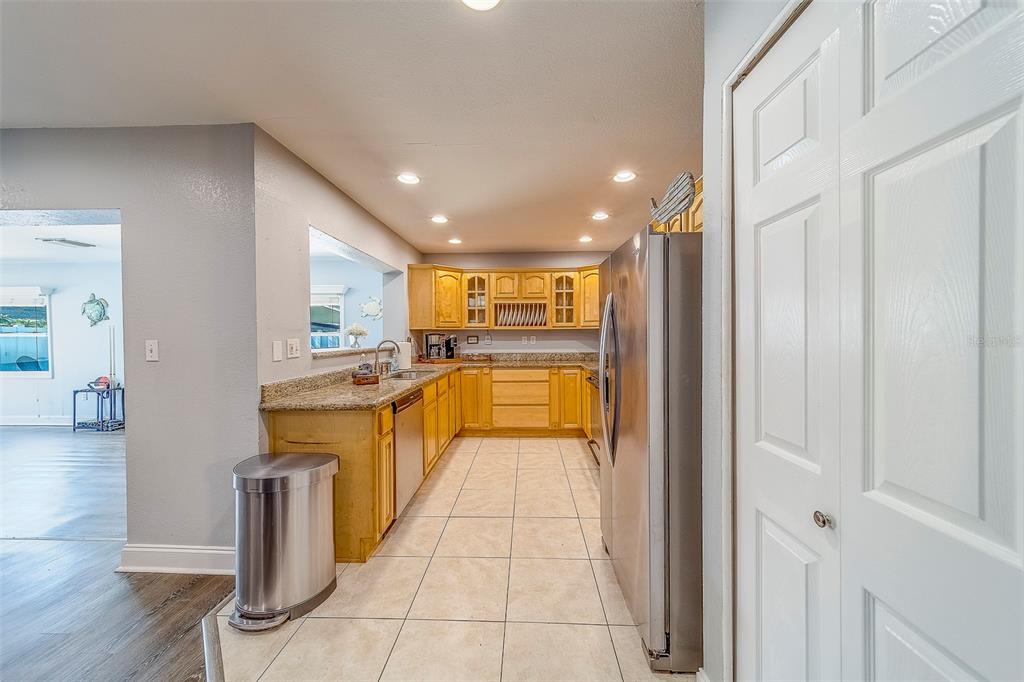 14414 91st Avenue North Seminole, FL 33776 - Photo 7 of 58 a view of a kitchen with kitchen island wooden floor and living room