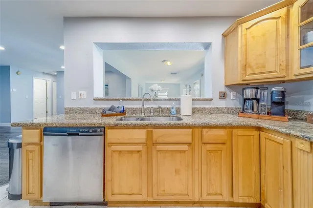 a kitchen with stainless steel appliances granite countertop a sink and cabinets