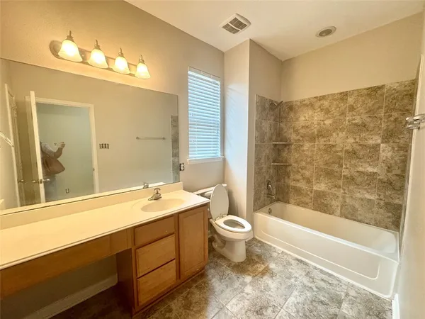 a view of room with a ceiling fan and window