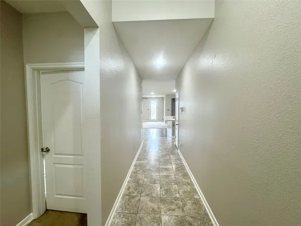 a view of a hallway with a wooden floor