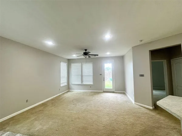 an empty room with windows and closet
