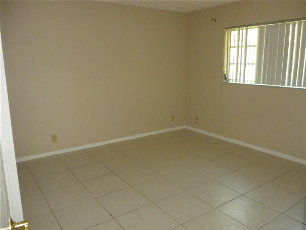 2131 Northeast 41st Street, Unit 107 Lighthouse Point, FL 33064 - Photo 15 of 18 an empty room with a window