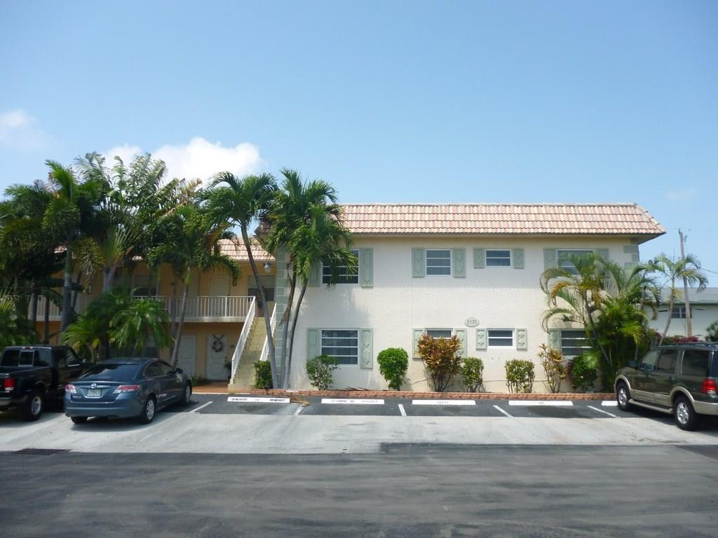 2131 Northeast 41st Street, Unit 107 Lighthouse Point, FL 33064 - Photo 3 of 18 a view of a house with car parked beside of it