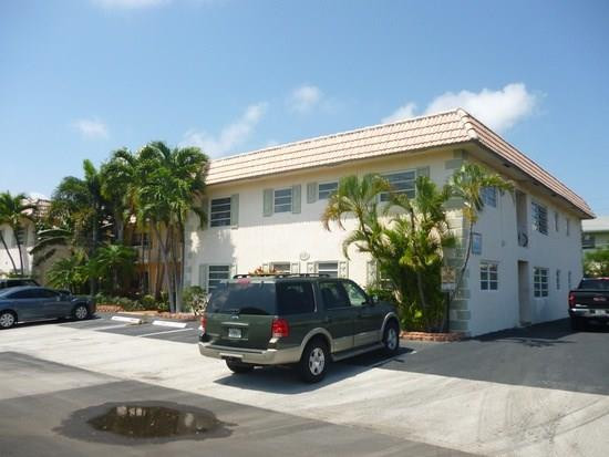 2131 Northeast 41st Street, Unit 107 Lighthouse Point, FL 33064 - Photo 7 of 18 a car parked in front of a house
