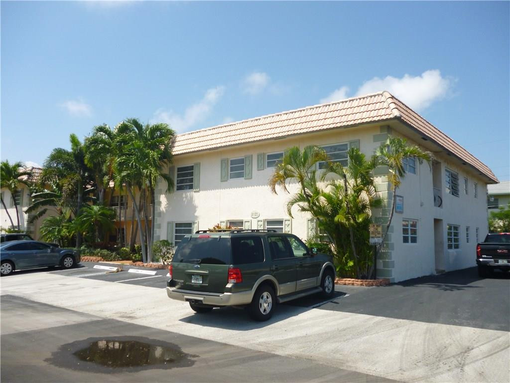 2131 Northeast 41st Street, Unit 107 Lighthouse Point, FL 33064 - Photo 8 of 18 a car parked in front of a house