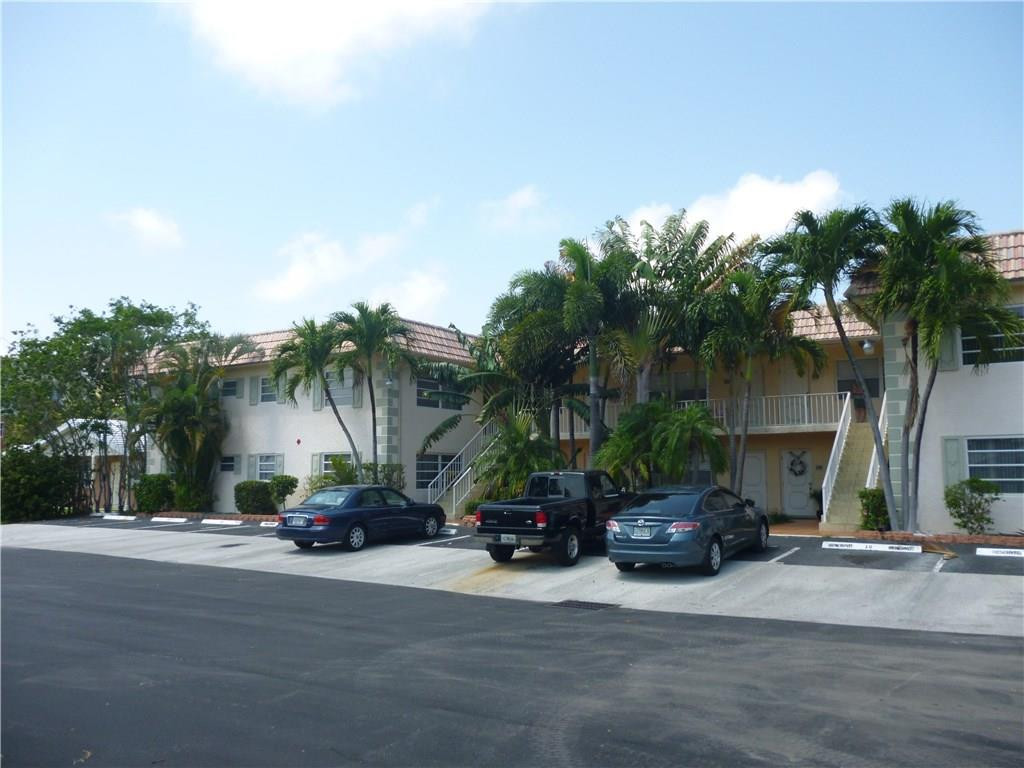 2131 Northeast 41st Street, Unit 107 Lighthouse Point, FL 33064 - Photo 10 of 18 a car parked on the side of a street