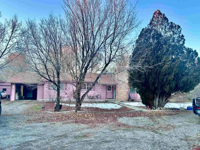 a view of a house with a snow in the yard
